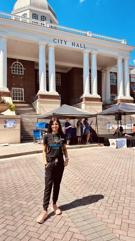 Dr. Suvidha Sachdeva of Sunshine Smiles Dentistry volunteering at Roswell City Hall providing dental exams